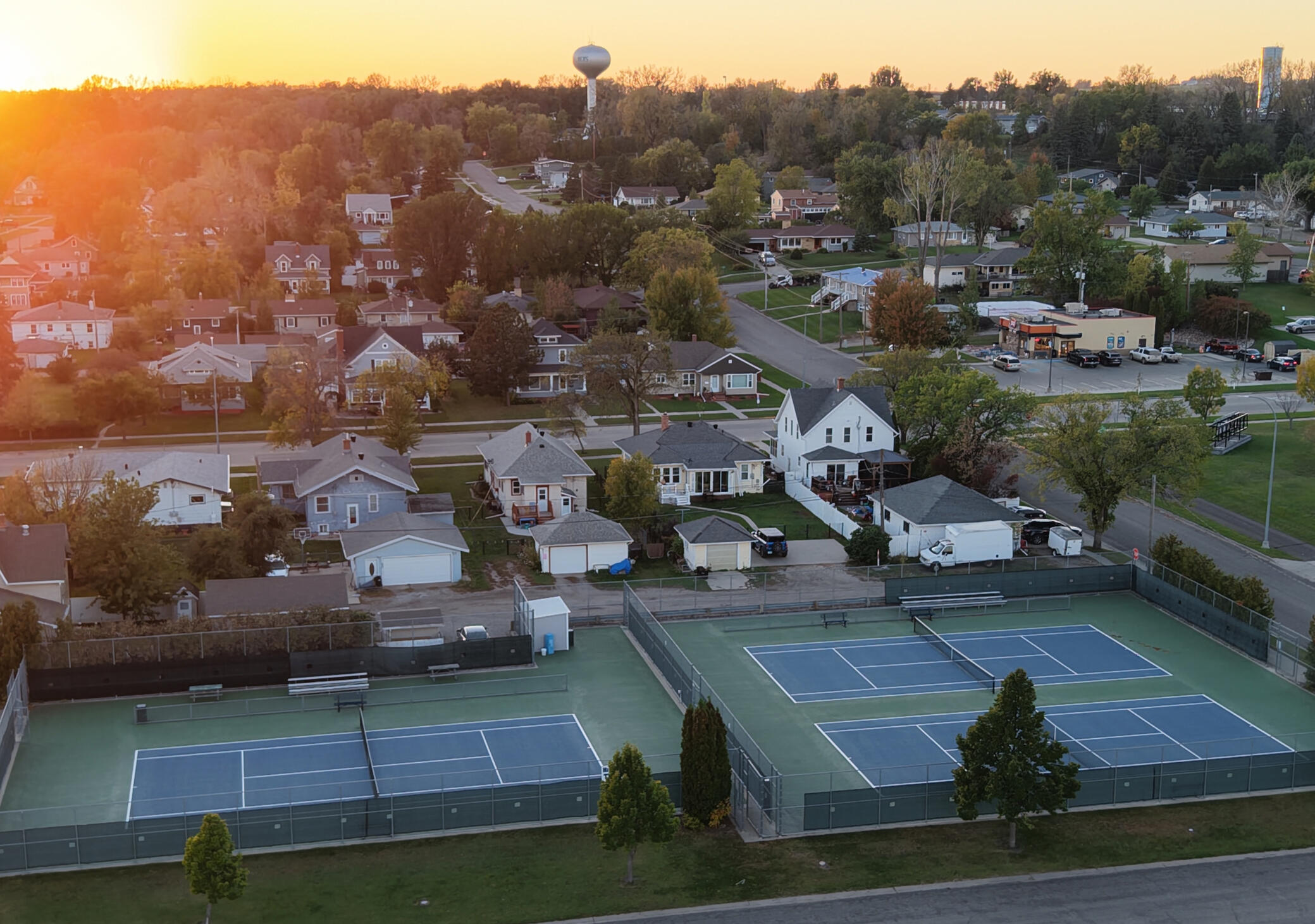 A picture of a neighborhood showing local tennis courts.